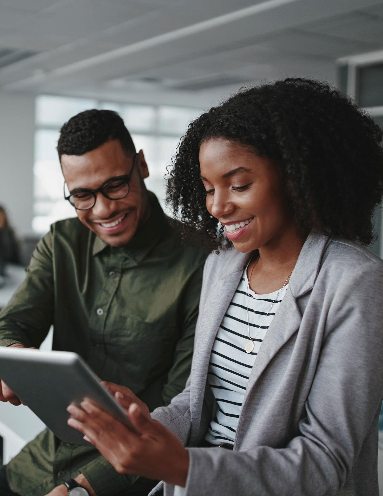 employees-working-together-looking-at-tablet